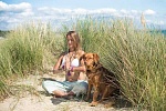 Meditating on a beach, with a dog